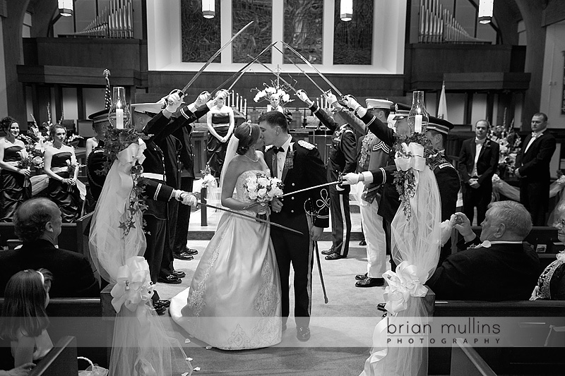 After the ceremony the newlyweds walk through an arch of sabers 